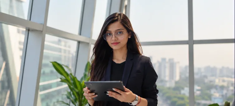 HR professional holding a tablet in a modern office