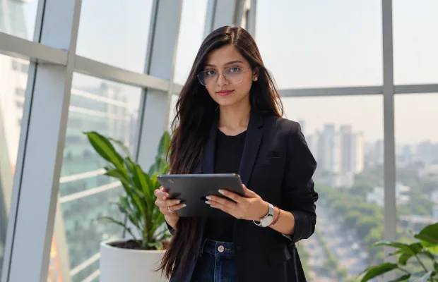 HR professional holding a tablet in a modern office